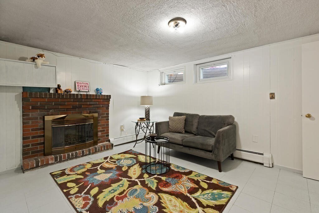 14 Tarbell Avenue Lexington, MA 02421 - Photo 21 of 30 a living room with furniture and a fireplace