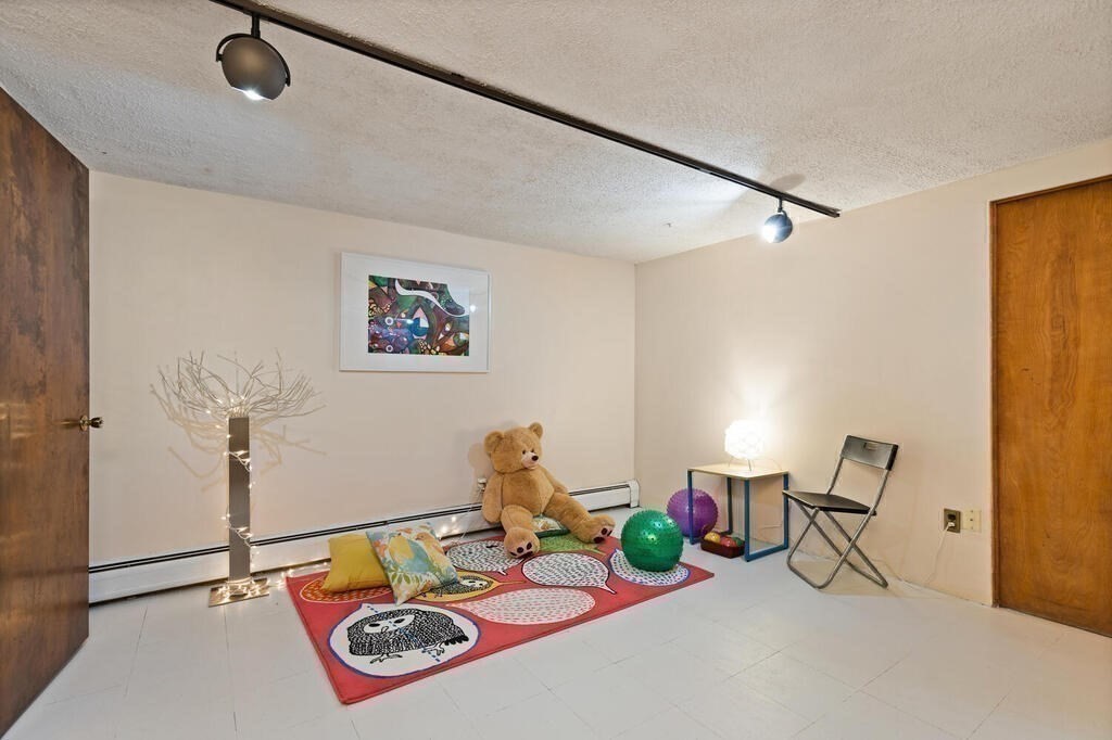 14 Tarbell Avenue Lexington, MA 02421 - Photo 23 of 30 a bedroom with furniture and a wooden floor