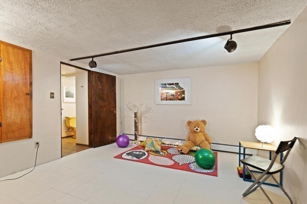 14 Tarbell Avenue Lexington, MA 02421 - Photo 24 of 30 a bedroom with furniture and a window