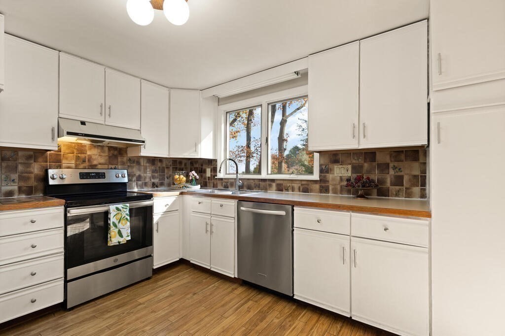 14 Tarbell Avenue Lexington, MA 02421 - Photo 9 of 30 a kitchen with granite countertop white cabinets and white appliances