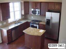 1132 Drayton Court, Unit 2202 Fort Mill, SC 29708 - Photo 1 of 3 a kitchen with stainless steel appliances granite countertop a sink stove and refrigerator