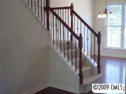 1132 Drayton Court, Unit 2202 Fort Mill, SC 29708 - Photo 2 of 3 a view of staircase with lots of frames on wall and a window