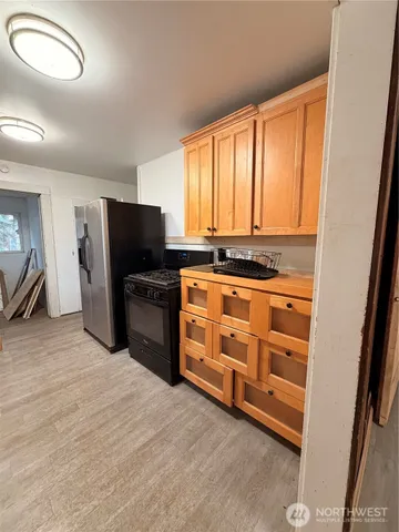 a kitchen with stainless steel appliances a stove top oven and refrigerator