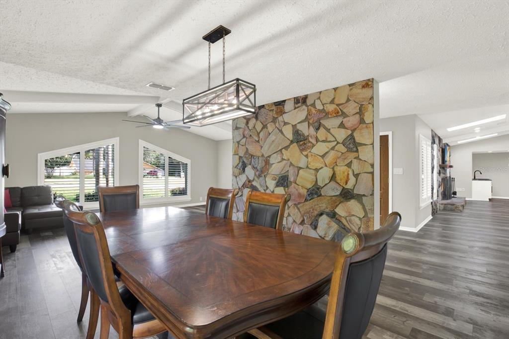 7487 River Country Drive Weeki Wachee, FL 34607 - Photo 11 of 53 a view of a dining room with furniture and wooden floor