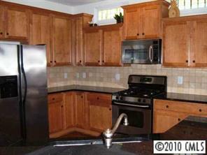 221 Mills Lane Fort Mill, SC 29708 - Photo 3 of 8 a kitchen with stainless steel appliances granite countertop a stove a refrigerator and a microwave