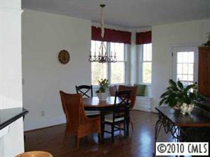 221 Mills Lane Fort Mill, SC 29708 - Photo 4 of 8 a view of a dining room with furniture window and wooden floor