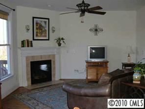 221 Mills Lane Fort Mill, SC 29708 - Photo 5 of 8 a living room with furniture a flat screen tv and a fireplace