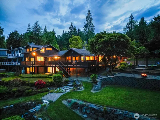 a front view of a house with swing and a garden