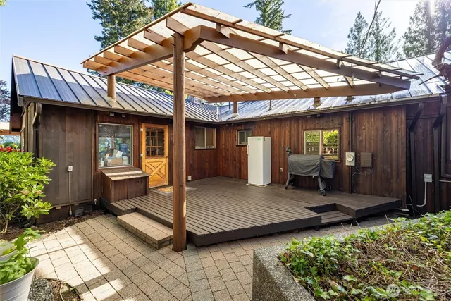 a view of a chair and table in backyard of the house