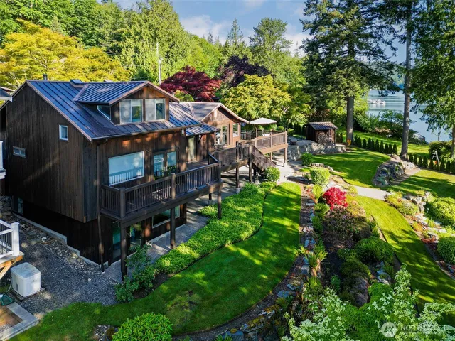 a view of a house with a backyard and tree