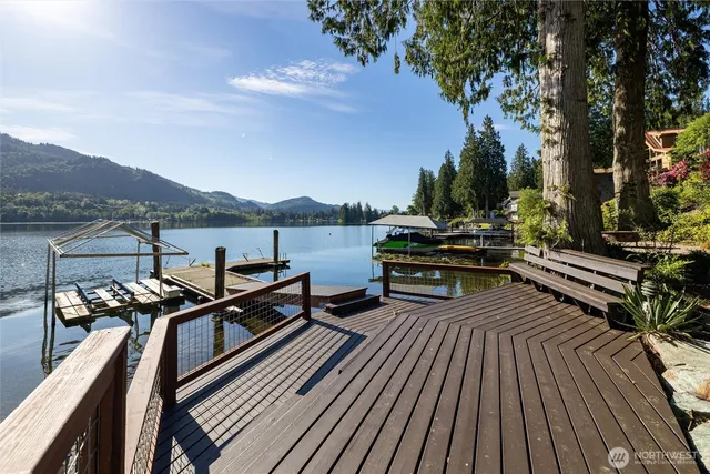 a view of a balcony with wooden floor and outdoor seating