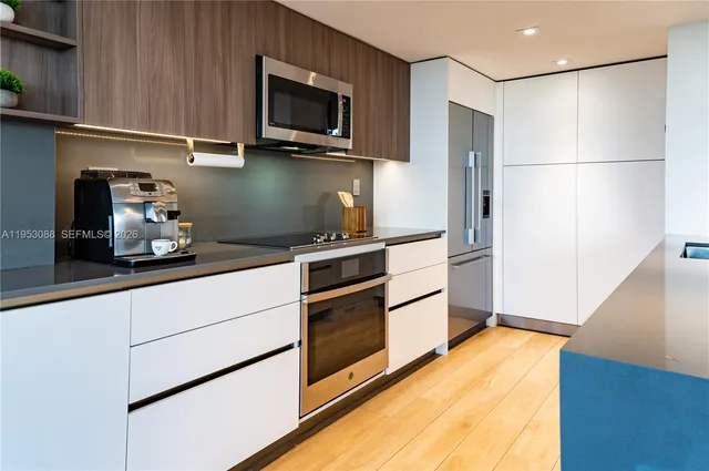 a kitchen with stainless steel appliances a refrigerator and a stove top oven