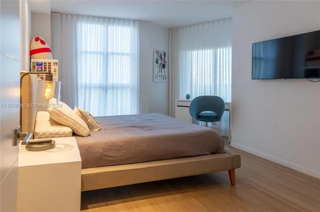 a bedroom with a bed and window