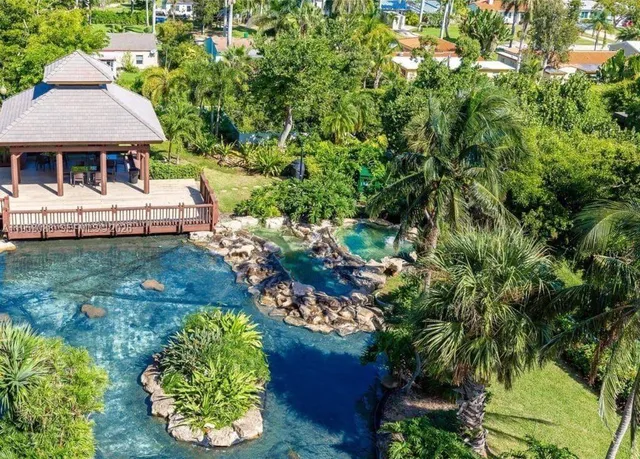 a front view of a house with a yard and fountain