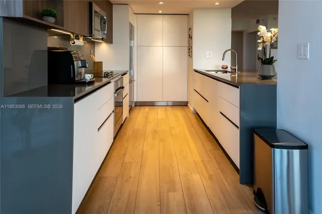 a kitchen with granite countertop lots of counter top space and stainless steel appliances