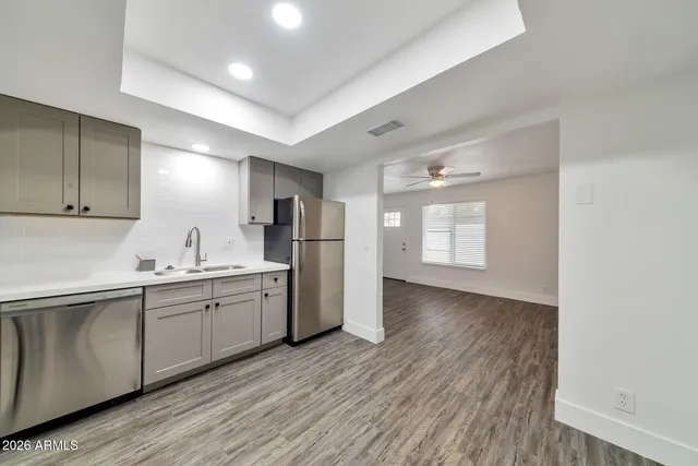 a kitchen with refrigerator and cabinets