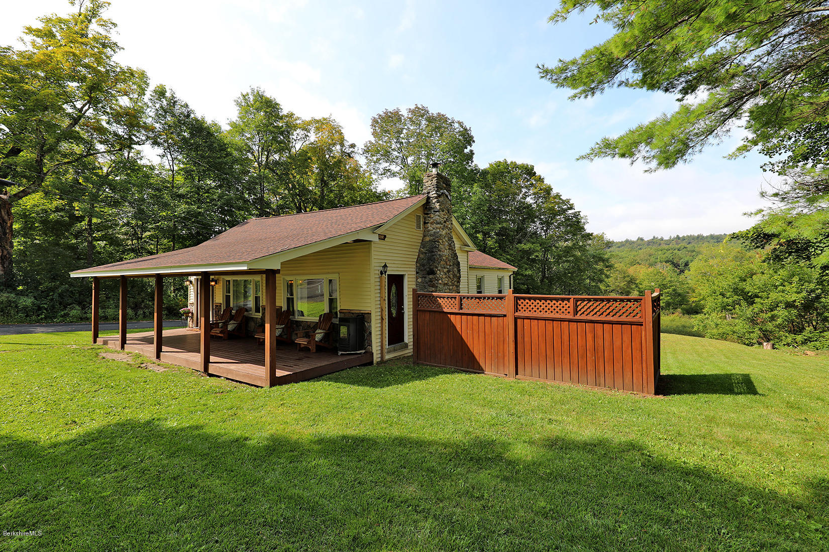 a view of a house with a backyard
