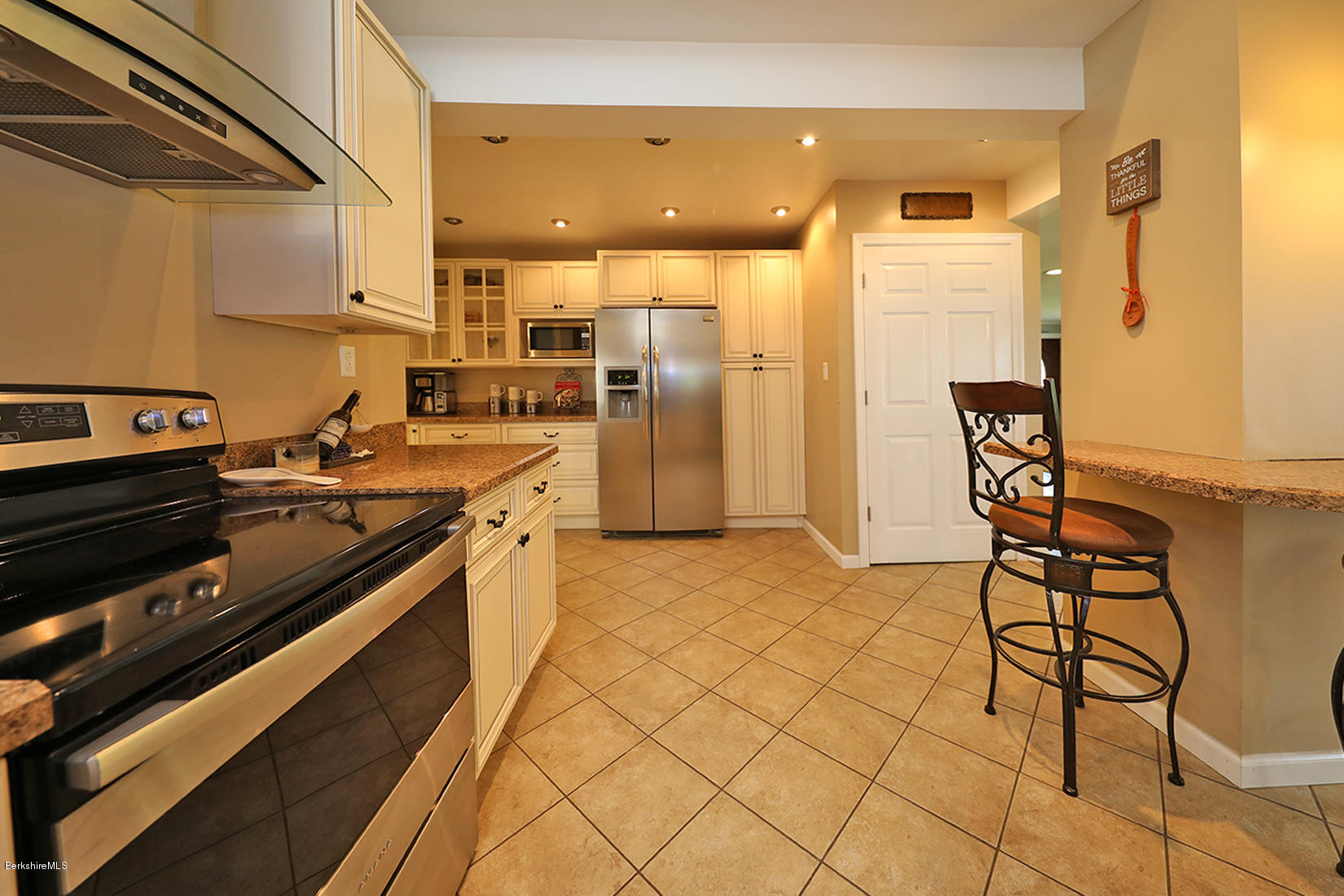 14 Ed Jones Road Otis, MA 01253 - Photo 11 of 28 a kitchen with stainless steel appliances granite countertop a stove a sink and a refrigerator