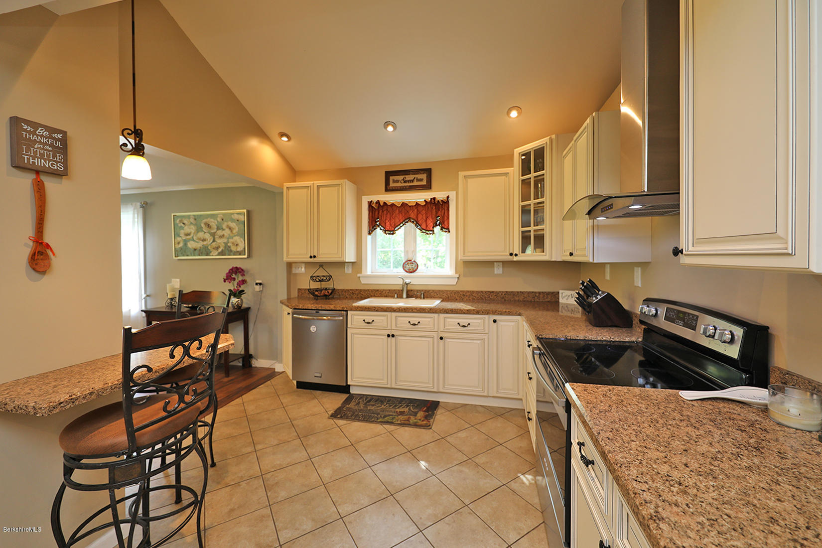 14 Ed Jones Road Otis, MA 01253 - Photo 13 of 28 a kitchen with a stove a sink a dining table and chairs