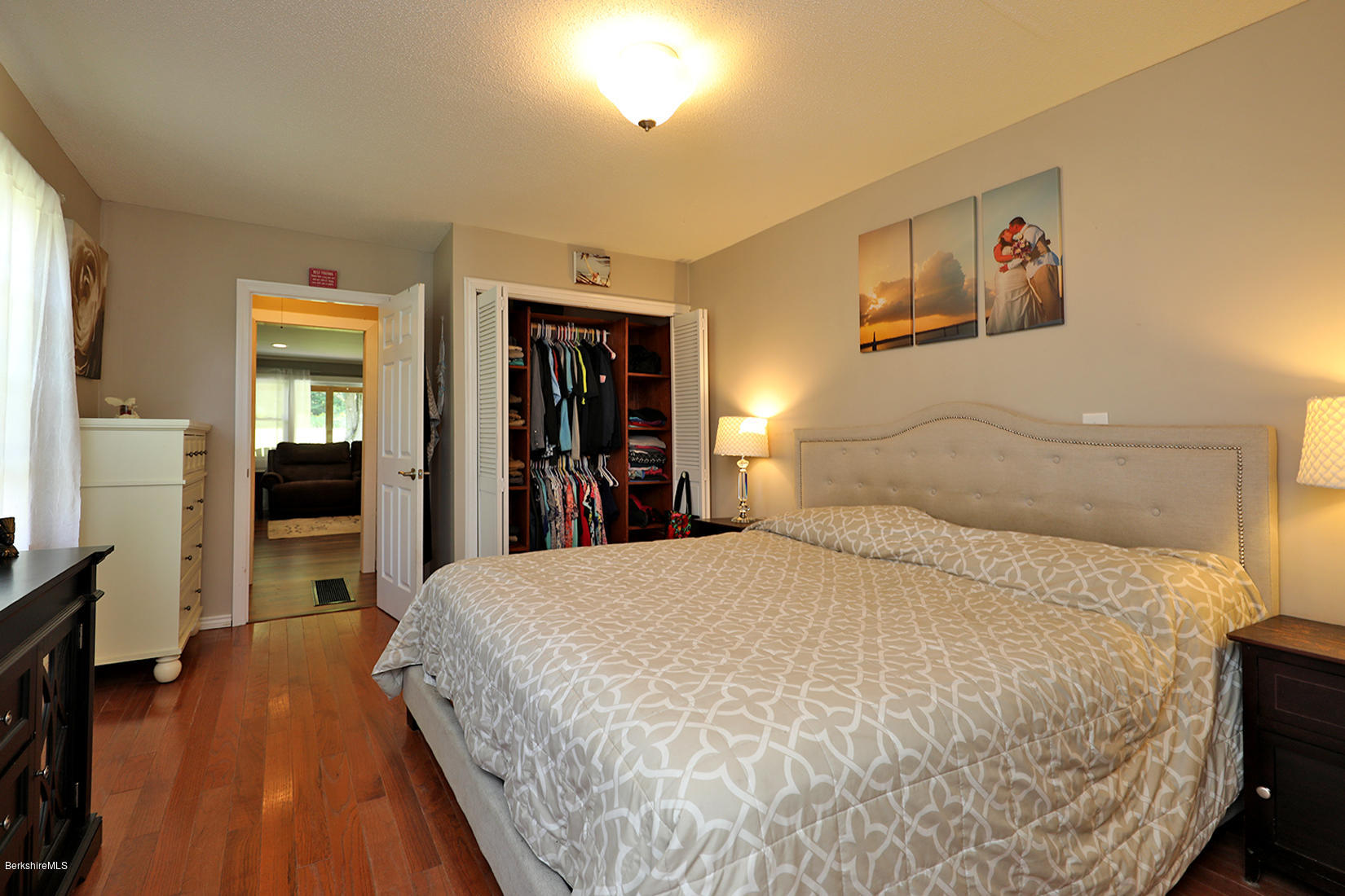 14 Ed Jones Road Otis, MA 01253 - Photo 16 of 28 a bedroom with a large bed and a flat tv screen on dresser