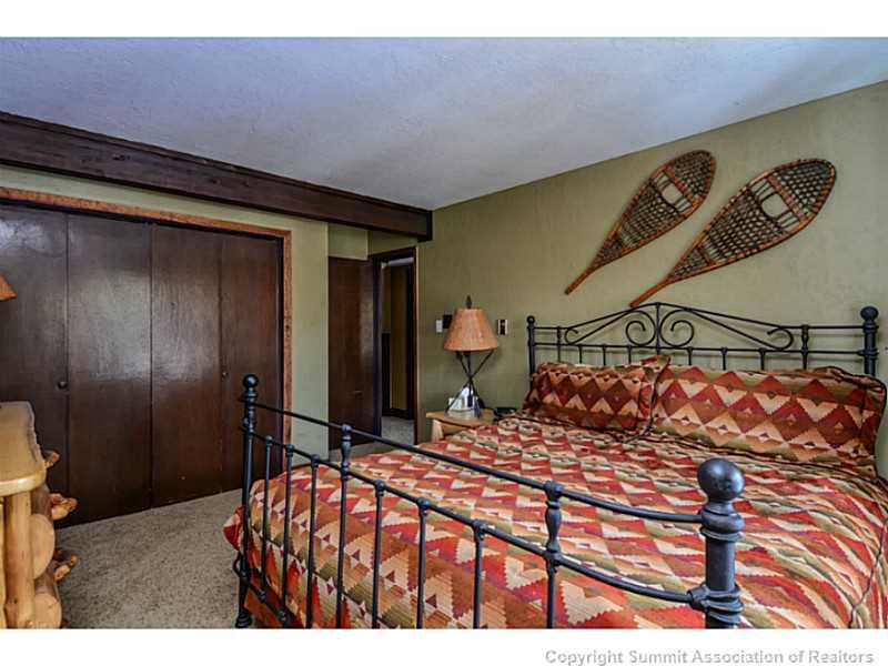 820 Columbine Road, Unit 16B Breckenridge, CO 80424 - Photo 13 of 23 a bedroom with a bed and a walk in closet