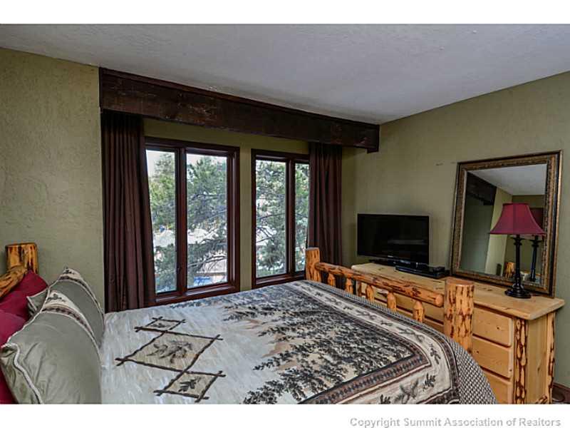 820 Columbine Road, Unit 16B Breckenridge, CO 80424 - Photo 17 of 23 a living room with a flat screen tv and a fireplace