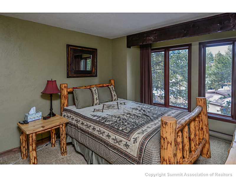 820 Columbine Road, Unit 16B Breckenridge, CO 80424 - Photo 18 of 23 a bed sitting in a bedroom next to a window