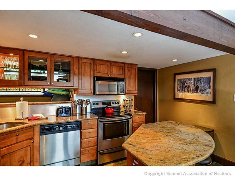 820 Columbine Road, Unit 16B Breckenridge, CO 80424 - Photo 5 of 23 a kitchen with stainless steel appliances granite countertop a stove and a sink
