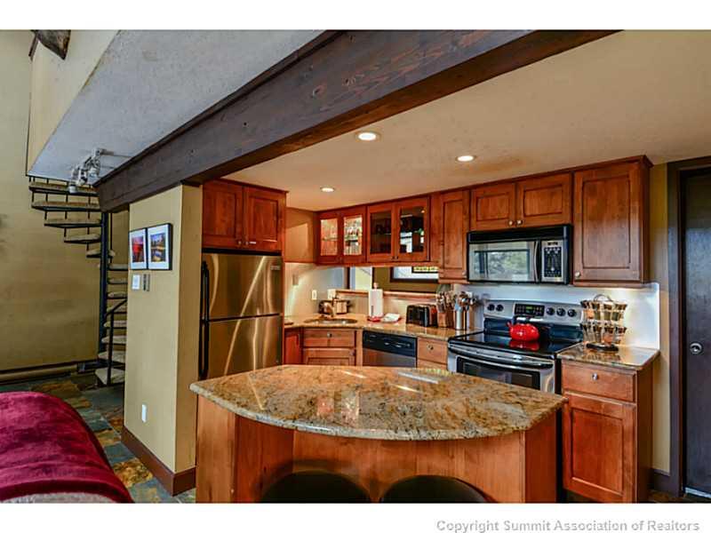 820 Columbine Road, Unit 16B Breckenridge, CO 80424 - Photo 6 of 23 a kitchen with stainless steel appliances granite countertop a sink refrigerator and cabinets