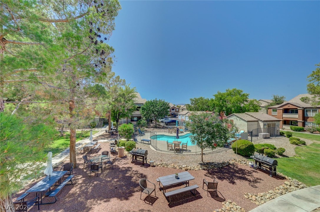 555 East Silverado Ranch Boulevard, Unit 2124 Las Vegas, NV 89183 - Photo 36 of 47 An inviting outdoor community area features a sparkling pool and multiple barbecue stations.