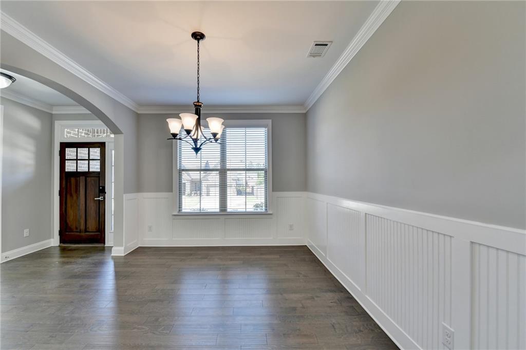 4217 Heisenberg Lane Suwanee, GA 30024 - Photo 11 of 72 a view of a room with wooden floor chandelier and windows