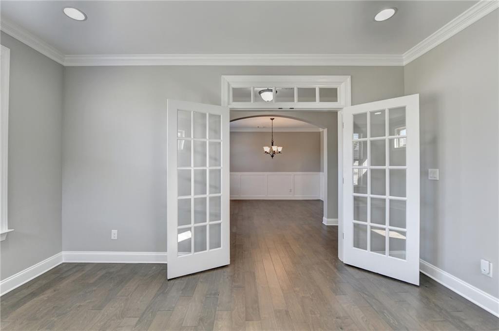 4217 Heisenberg Lane Suwanee, GA 30024 - Photo 14 of 72 an empty room with wooden floor and cabinet