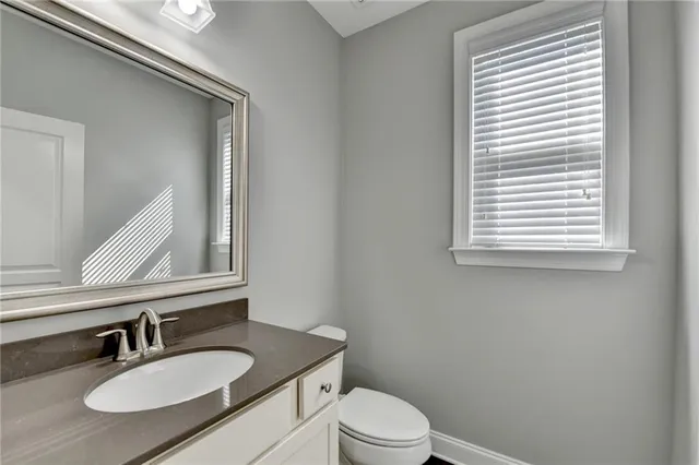 a large white kitchen with white cabinets and stainless steel appliances
