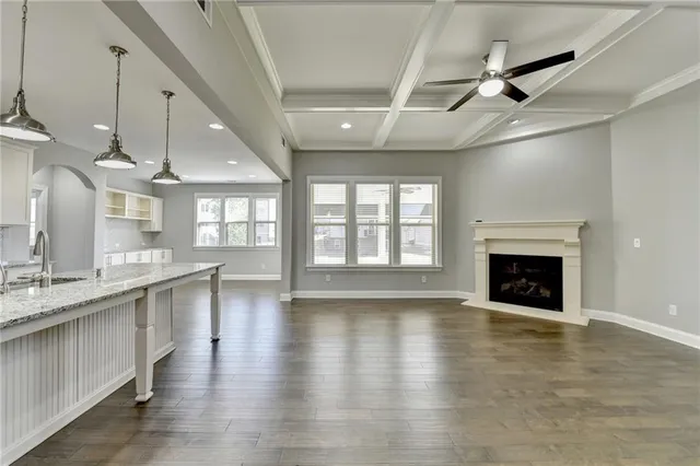 a kitchen with stainless steel appliances granite countertop a sink a refrigerator a stove a microwave and island