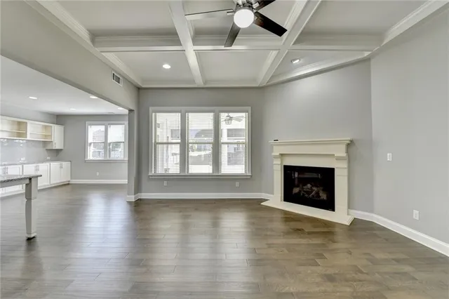 a kitchen with stainless steel appliances granite countertop a sink a stove and a wooden floors