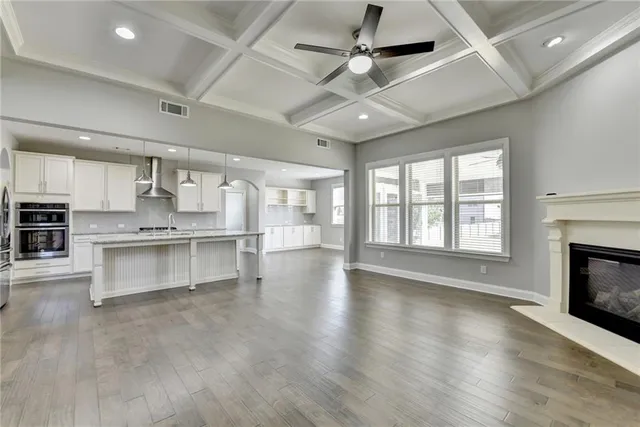 a kitchen with granite countertop white cabinets and stainless steel appliances
