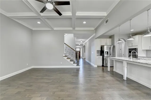 a kitchen with kitchen island granite countertop a stove and a sink
