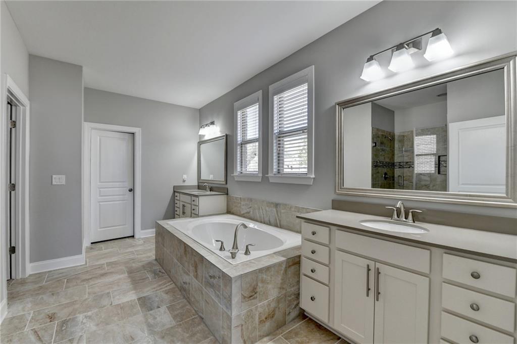 4217 Heisenberg Lane Suwanee, GA 30024 - Photo 36 of 72 a bathroom with a sink and a bathtub