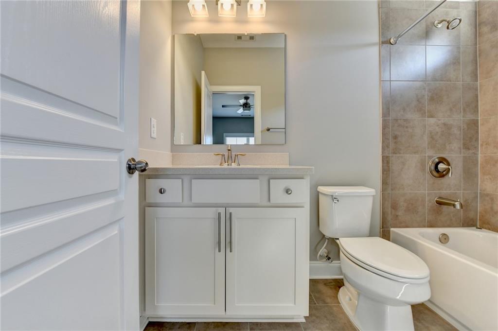 4217 Heisenberg Lane Suwanee, GA 30024 - Photo 54 of 72 a white toilet sitting next to a bathroom sink