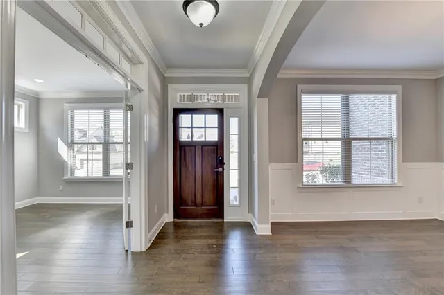 a view of a room with cabinet a ceiling fan and windows