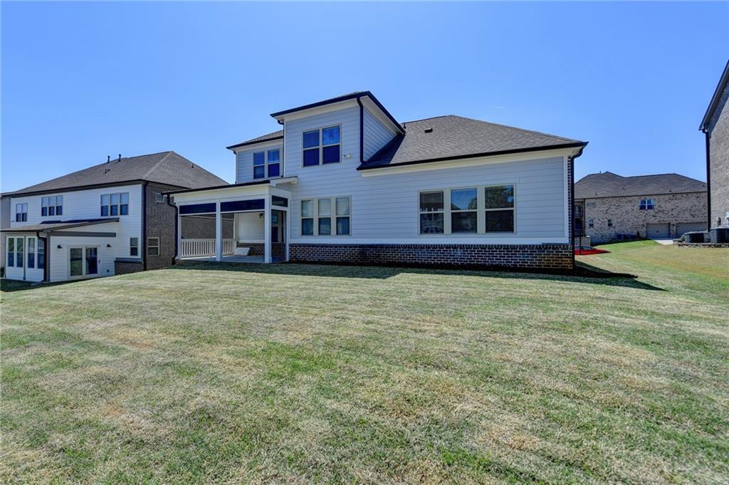 4217 Heisenberg Lane Suwanee, GA 30024 - Photo 61 of 72 a front view of a house with a garden and yard