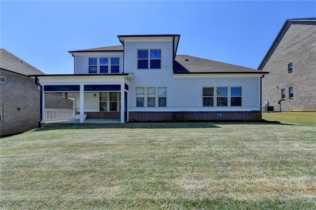 4217 Heisenberg Lane Suwanee, GA 30024 - Photo 62 of 72 a front view of a house with garden
