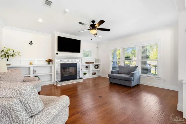 a living room with furniture fireplace and a flat screen tv
