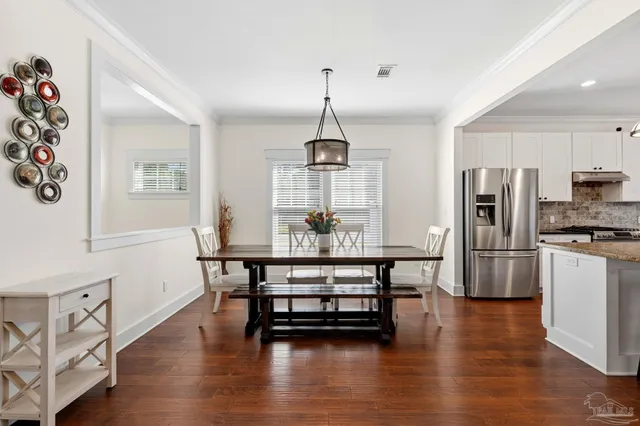 a dining room with furniture and wooden floor