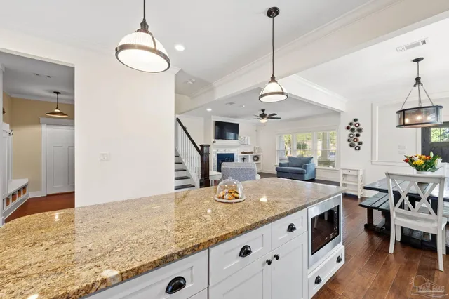 a view of living room and kitchen with granite countertop stove top oven