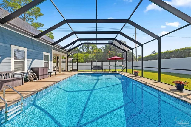 a room with pool table and glass windows