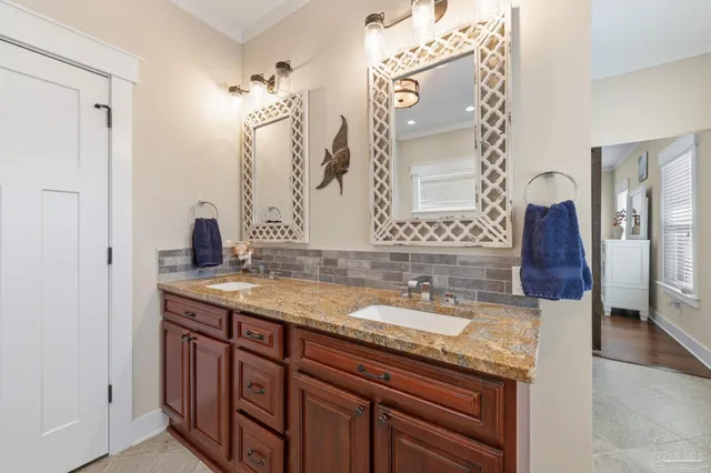 a bathroom with a tub a sink and a window