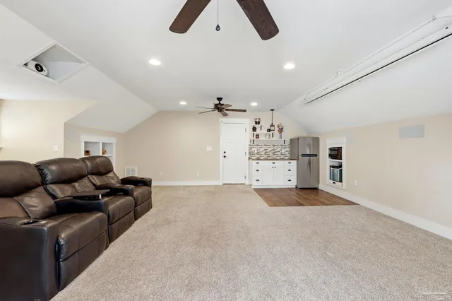 a living room with furniture and kitchen view