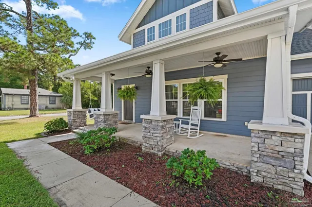 a view of a house with backyard and sitting area