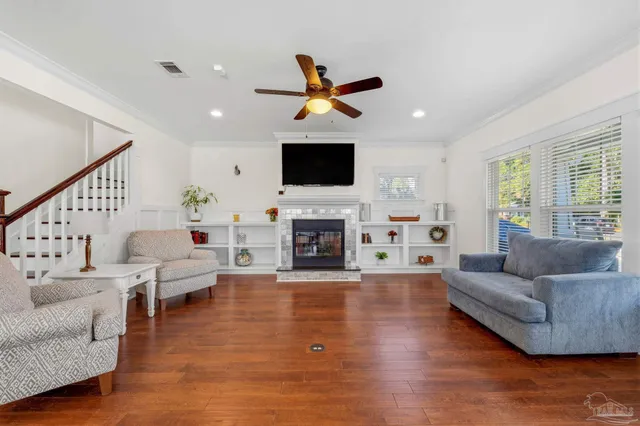 a living room with furniture fireplace and a flat screen tv